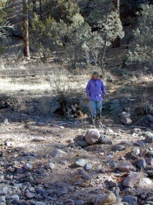 Diana crossing a dry stream near the beginning of the trail
